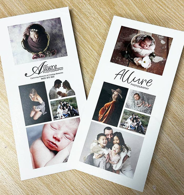 Two promotional brochures for Allure Photography on a wooden surface.