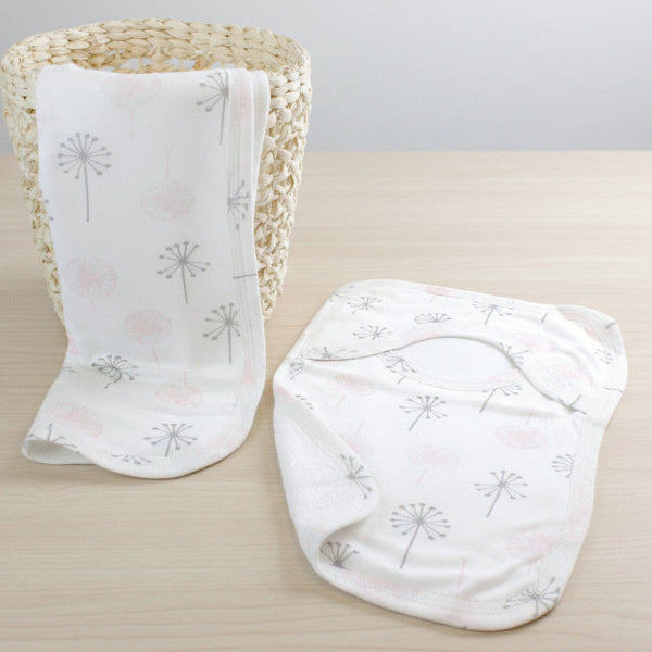 Two baby blankets with a dandelion pattern on a table