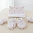 Baby hat, mittens, and booties set with 'XO' and heart patterns on a table