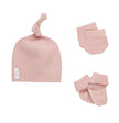 Pink baby hat and socks set on a white background