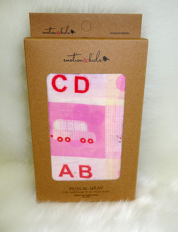 Emotion & Kids muslin wrap packaging with pink and red design on a white background