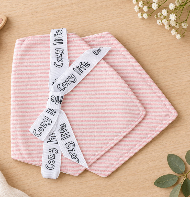 Two cotton baby Stripe Bandana Bibs on a table