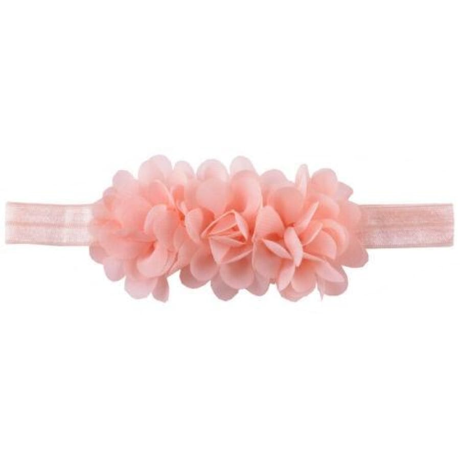 Pink headband with floral attachments on a white background