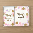 pink baby passport set on table