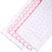 Pink and white, patterned blankets on a table background