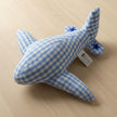 Blue and white checkered shark-shaped pillow with star details on a white background