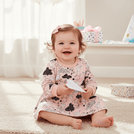 baby girl wearing dress with plane design