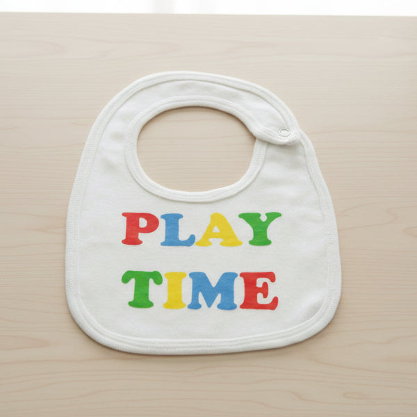 White bib with colorful 'PLAY TIME' text on a table background