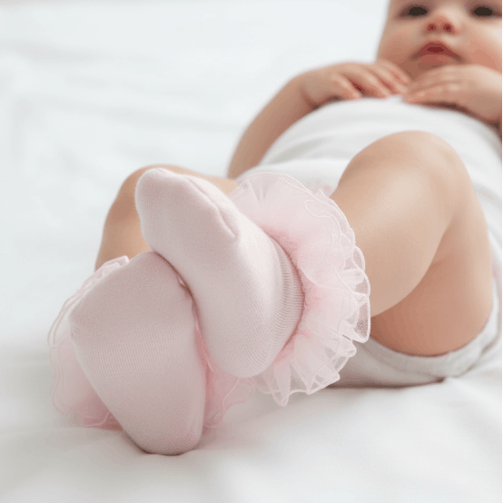 baby wearing pink socks