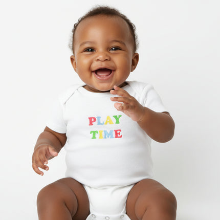 baby wearing white romper with play time wording