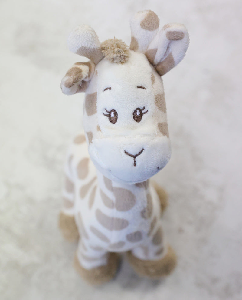 Plush giraffe toy on a soft white background