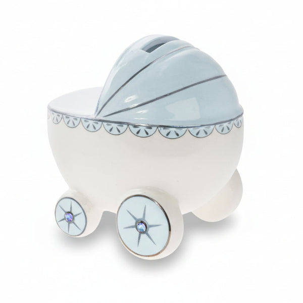 Ceramic baby carriage money box with decorative elements on a white background