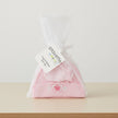 Pink baby hat with butterfly design in a clear bag, featuring a Playette label.