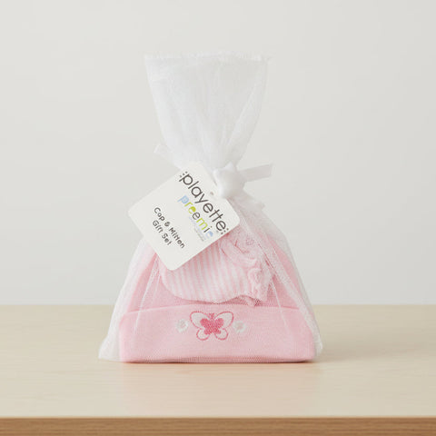 Pink baby hat with butterfly design in a clear bag, featuring a Playette label.