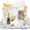Baby gift set with Moët champagne, Ferrero Rocher, and a Sophie la girafe toy on a white background.