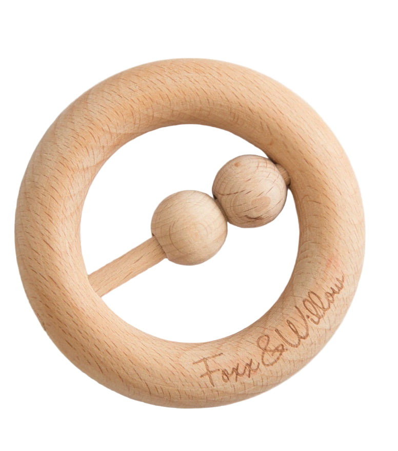 Wooden baby rattle with two beads on a white background