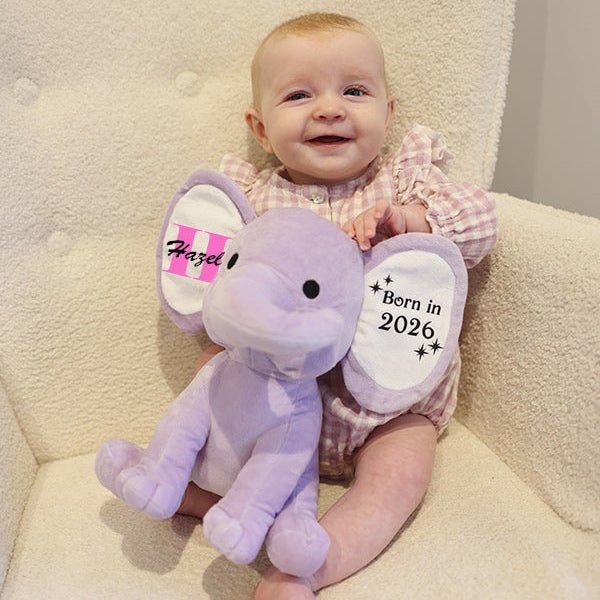 Baby sitting in chair with Purple Plush Elephant