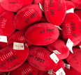 Red 'My First Football' toys with visible branding on a pile.