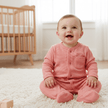 Baby wearing red suit sitting on a rug