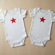 red star rompers on a table background