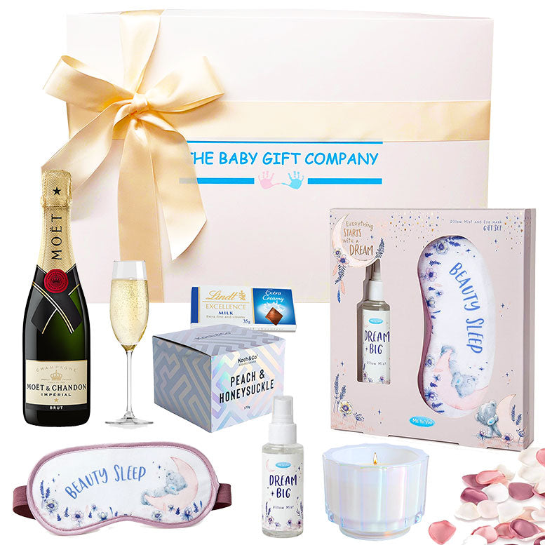 Gift set from The Baby Gift Company with Moet champagne, sleep mask, and other items.