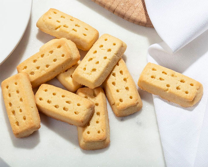 Shortbread cookies on a marble surface with a white napkin