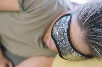 Person wearing a black and silver ice pack on their forehead