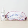 Sleep mask with 'Beauty Sleep' text and pillow mist bottle on a white background
