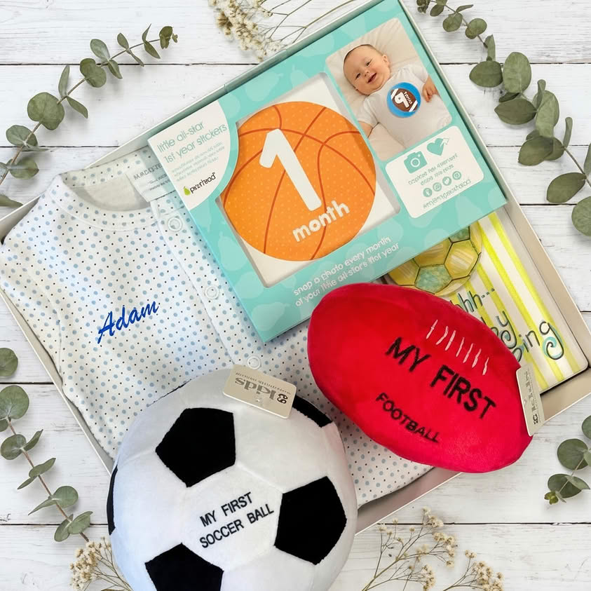 Collect of sporty baby gifts in a box footy and personalised baby clothes