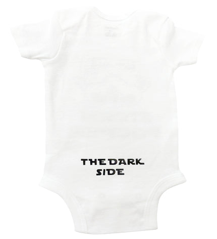 White baby onesie with 'THE DARK SIDE' text on a white background
