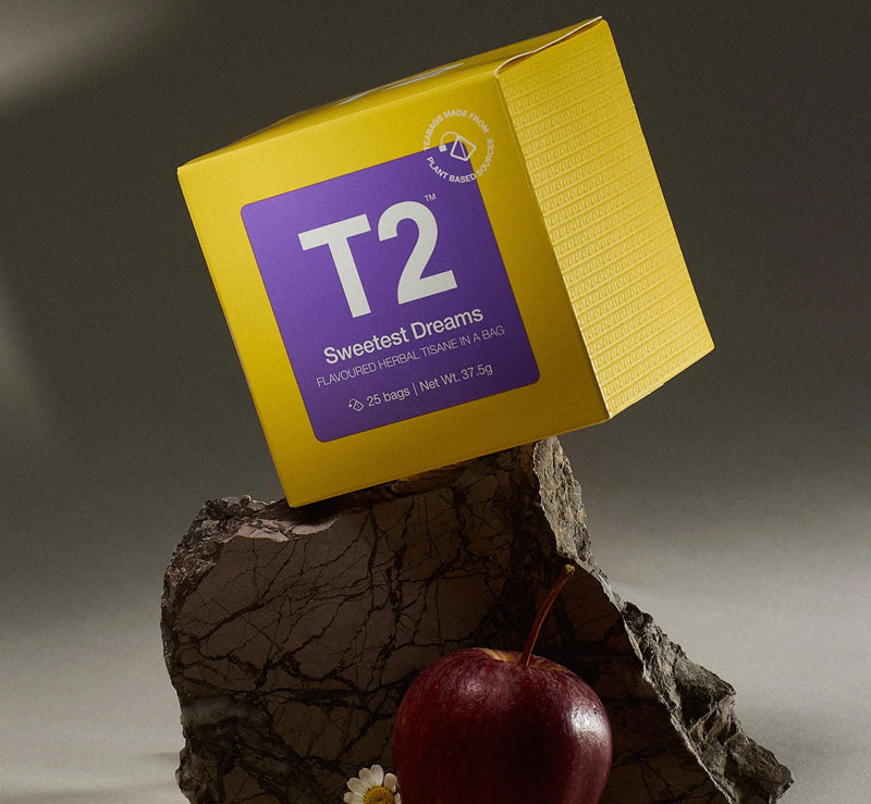 Sweetest Dreams calming herbal tea bag cube with chamomile and lavender on a rock with apple