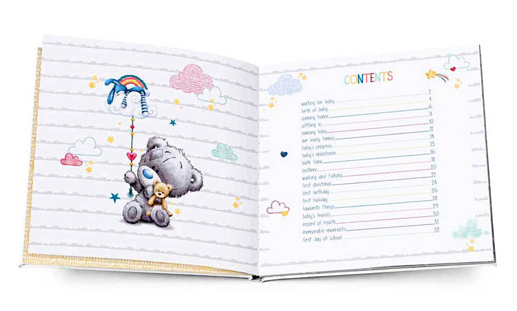 Open book with Tiny Tatty Teddy Baby bear and colorful illustrations on a white background