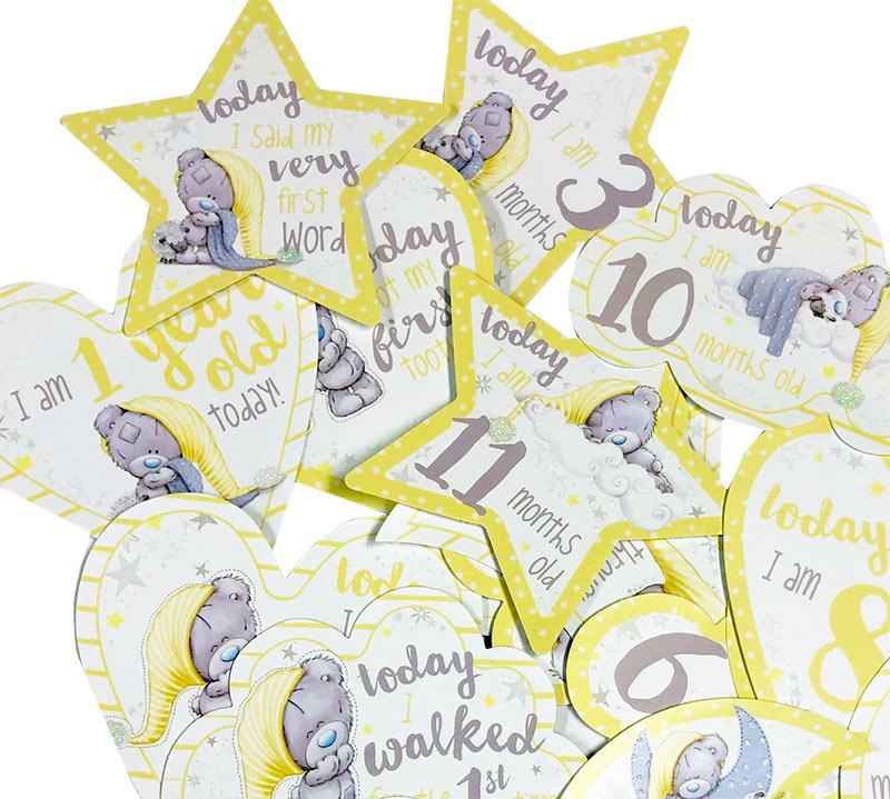 Collection of baby milestone cards with teddy bear illustrations and text.