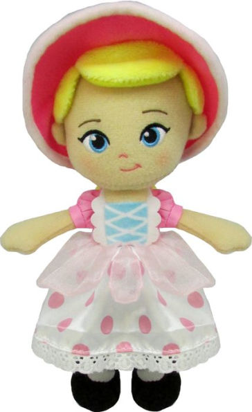 Plush toy doll with a pink dress and yellow hat on a white background