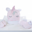 Baby hat and booties set with unicorn design on a table