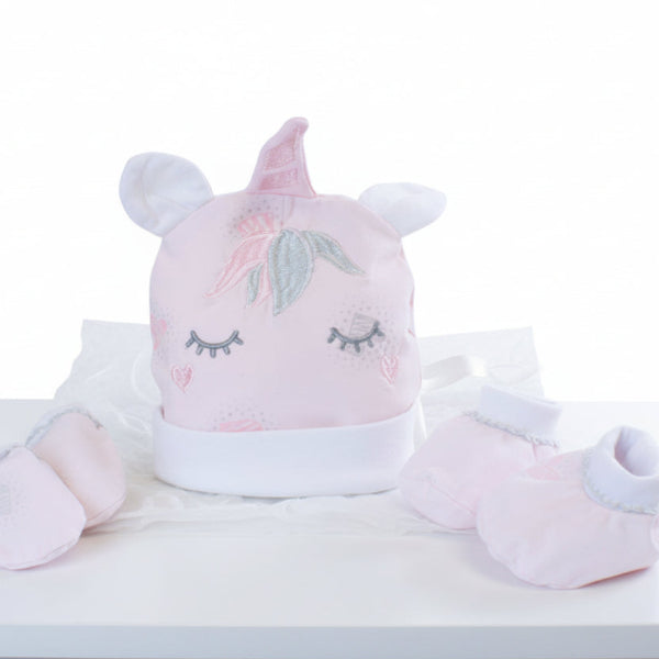 Baby hat and booties set with unicorn design on a table