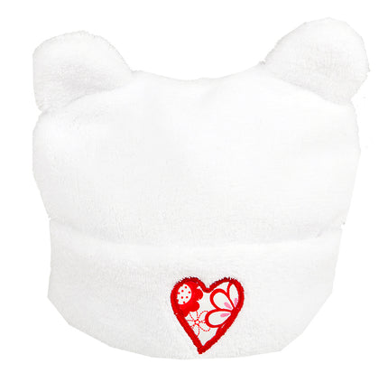 White bear-shaped hat with a red heart design on a white background