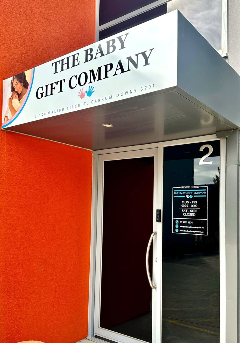 Storefront of 'The Baby Gift Company' with a sign above the entrance.