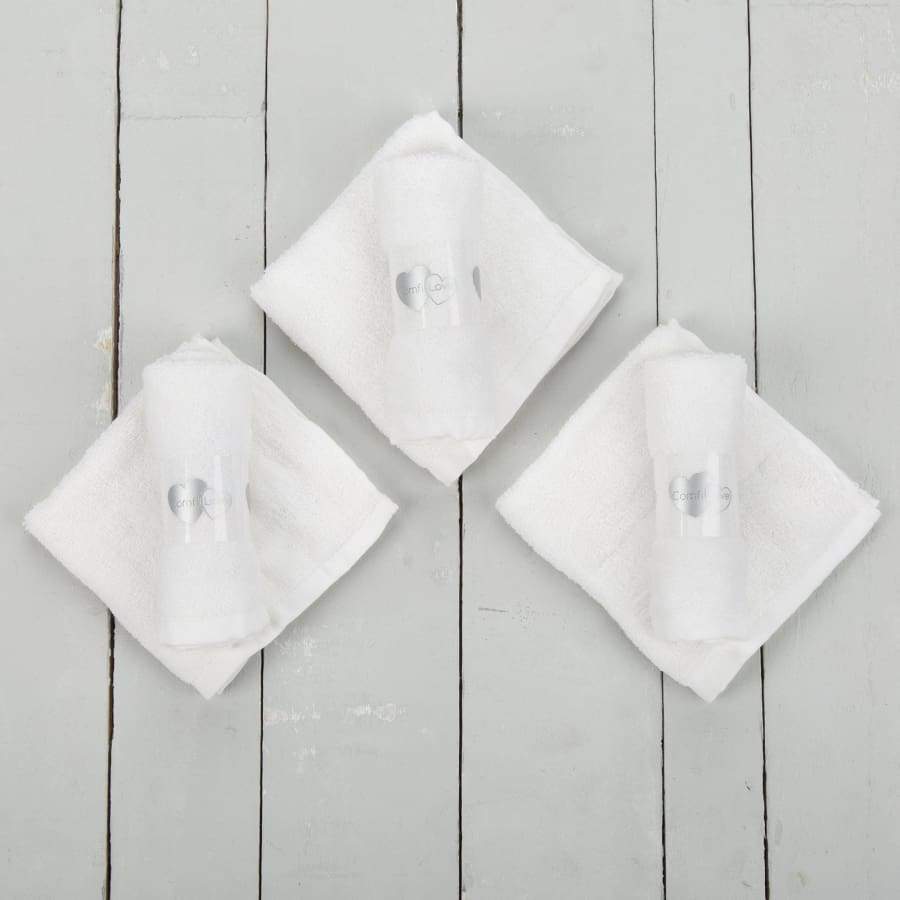 White baby face cloths on table