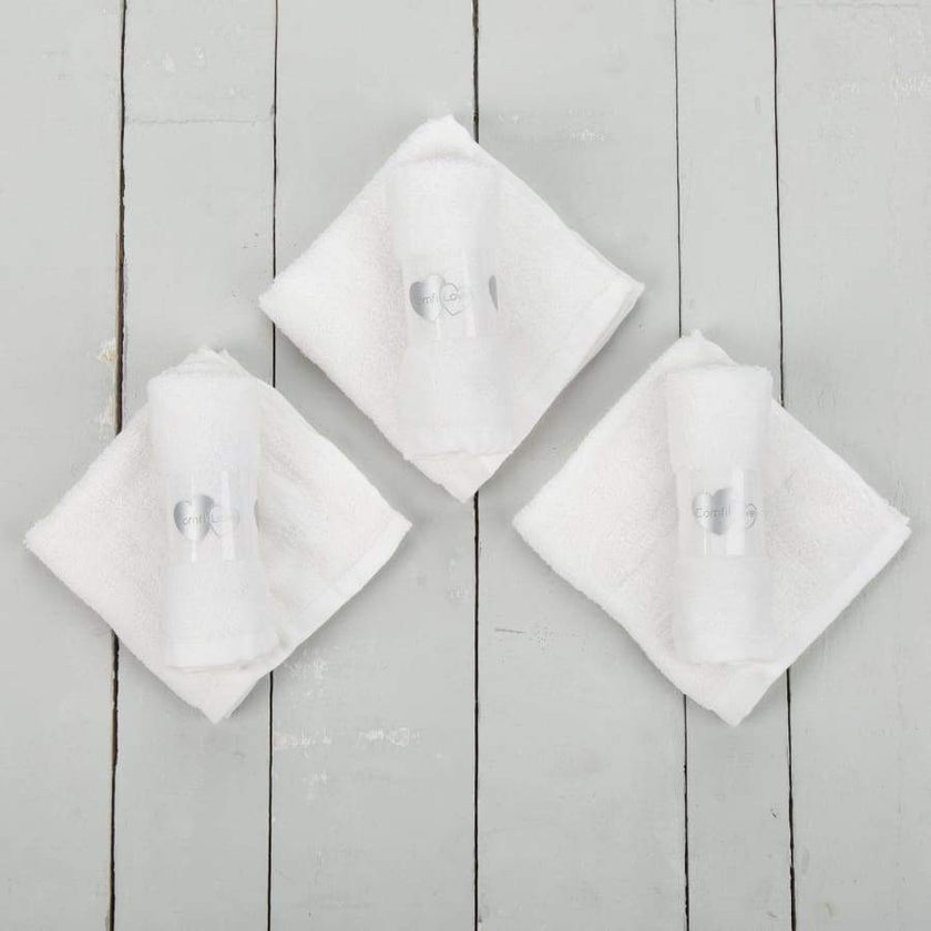 White baby face cloths on table