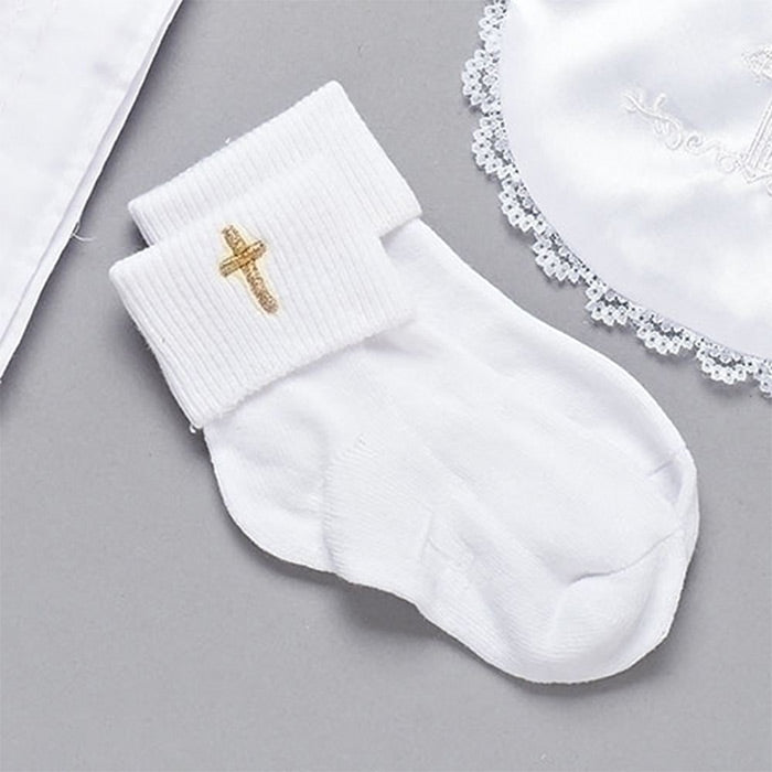 White sock with a gold cross on a gray surface