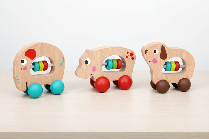 Three wooden animal toys with colorful beads on a white background