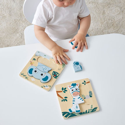 Two Wooden animal Puzzles with a child on a table