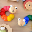 Colorful wooden caterpillar toys on a wooden surface