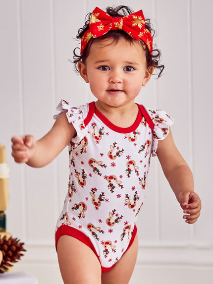 Baby wearing a red and white patterned onesie with a matching headband against a white background