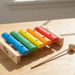 Colorful wooden xylophone with a mallet on a table