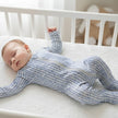 Baby sleeping in blue all in one suit